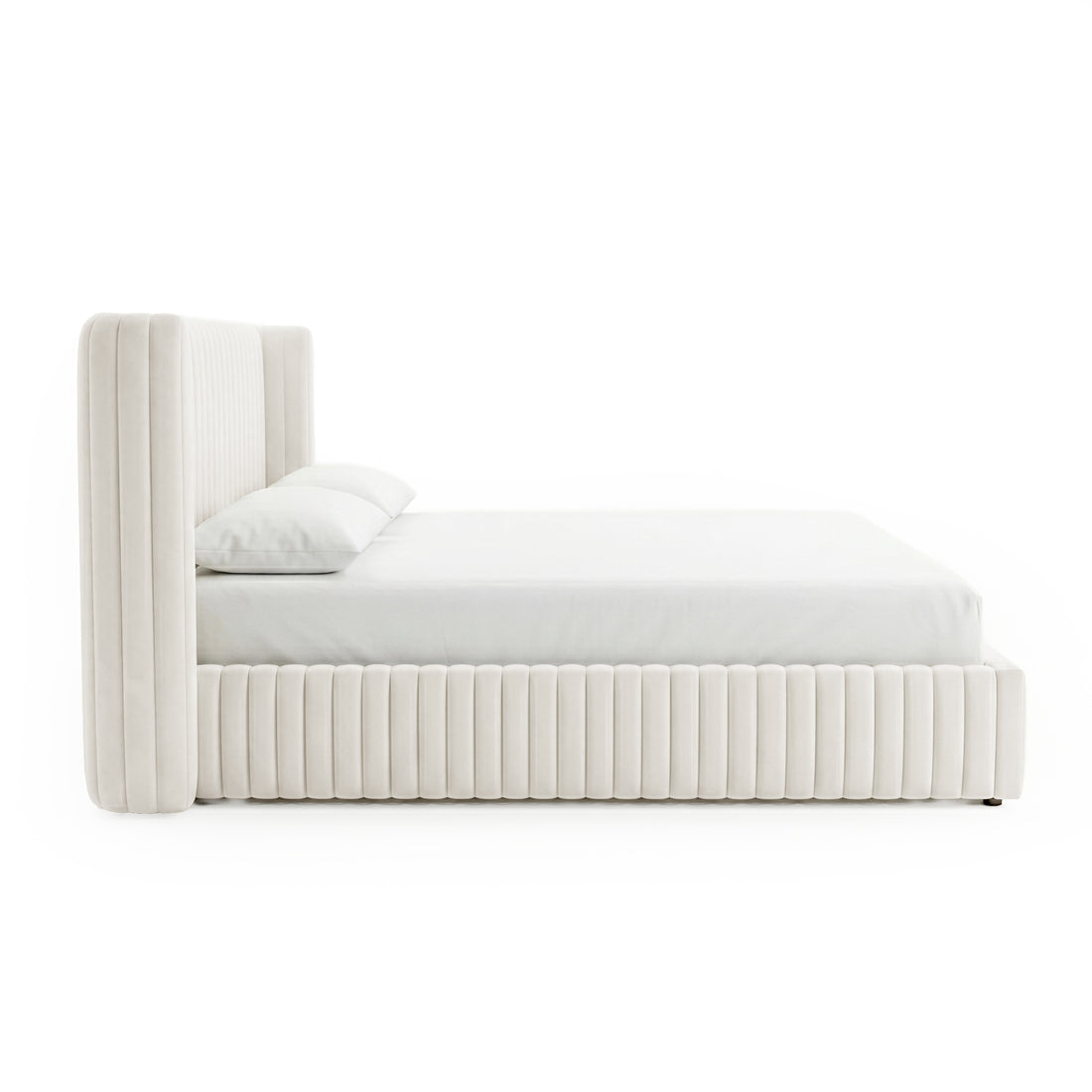 Side view of a cream upholstered platform bed with tall headboard