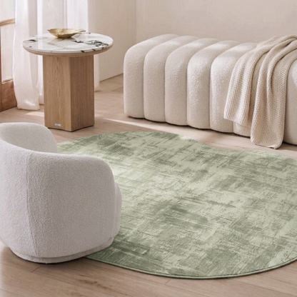 Abstract green rug in a modern furnished room with chair and side table