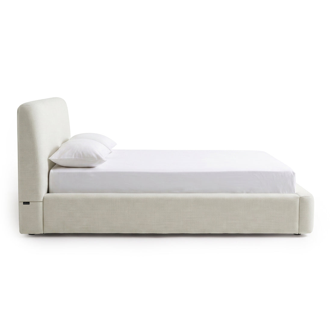 Contemporary upholstered bed shown in side profile on a white background