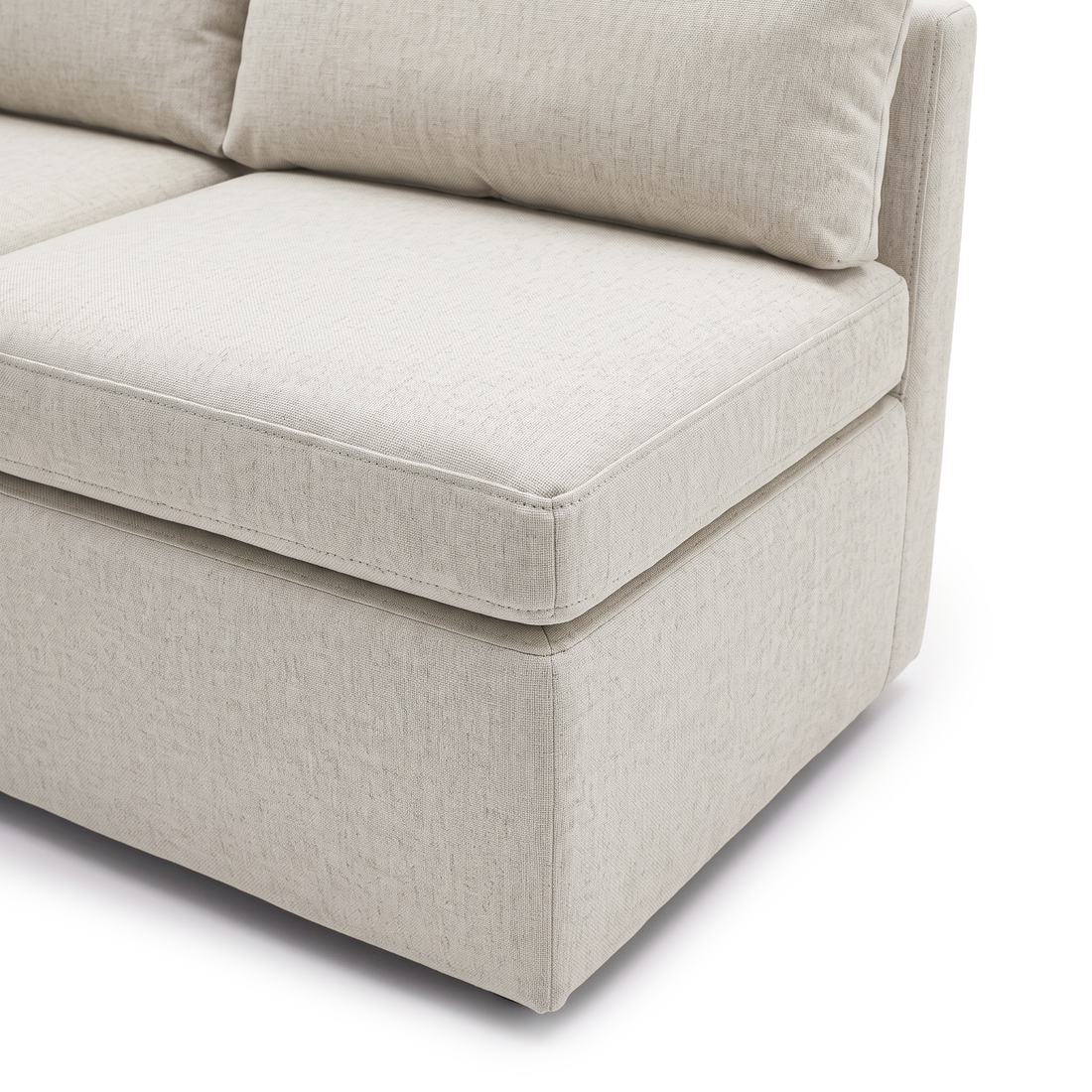 Close-up of cream sofa seat, back cushion, and upholstered side