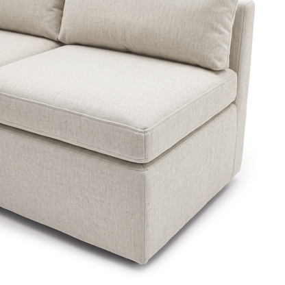 Close-up of cream sofa seat, back cushion, and upholstered side