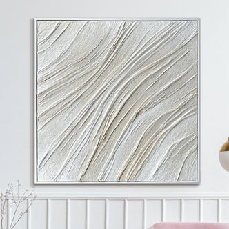Anya Canvas Wall Art 105 x 105cm in White features textured wave-like ridges on a square canvas, framed in white, above wainscoting with a blush-pink seat and metal pendant lamp nearby.