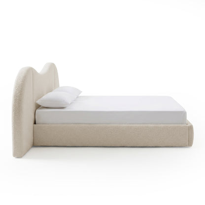 Side view of upholstered bed on white background