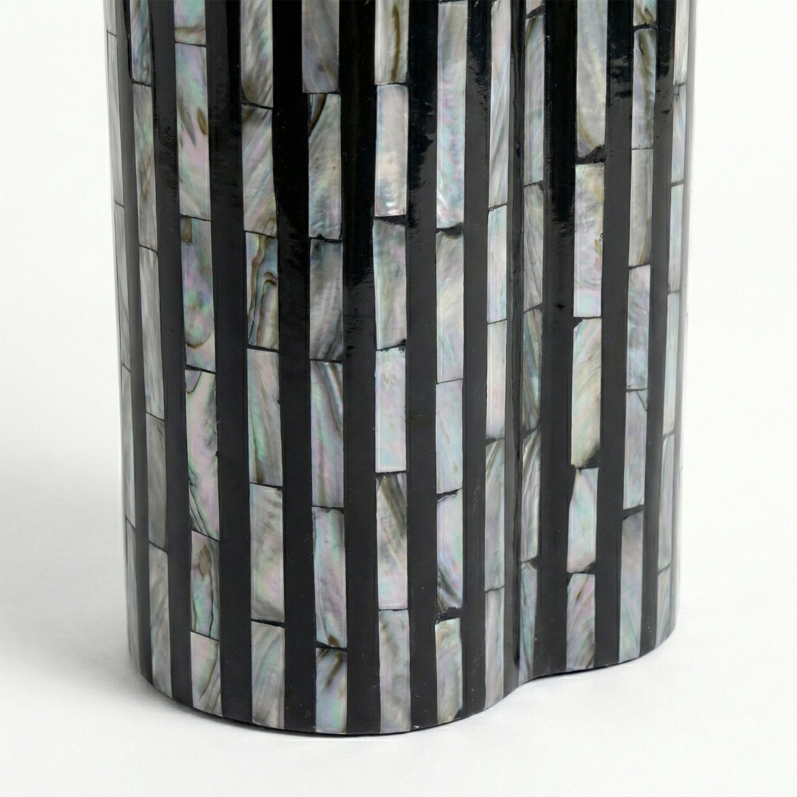 Close-up of reflective shell and black stripe mosaic pattern on white background