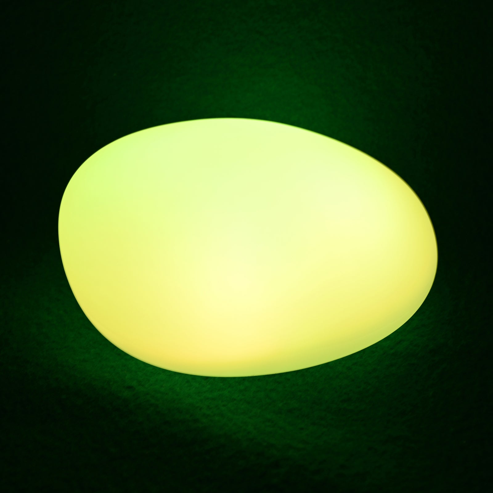 Solar Outdoor LED Rock Light Waterproof Garden Lamp, oval-shaped, emits a soft yellowish-green glow, resembling a natural stone, ideal for illuminating garden paths or beds with ambient light.
