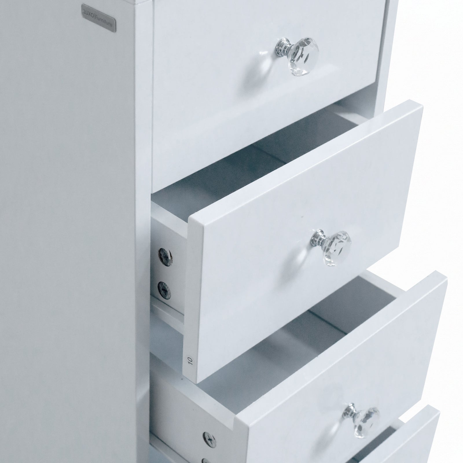 Close-up of drawer knobs and top drawer detail on white background