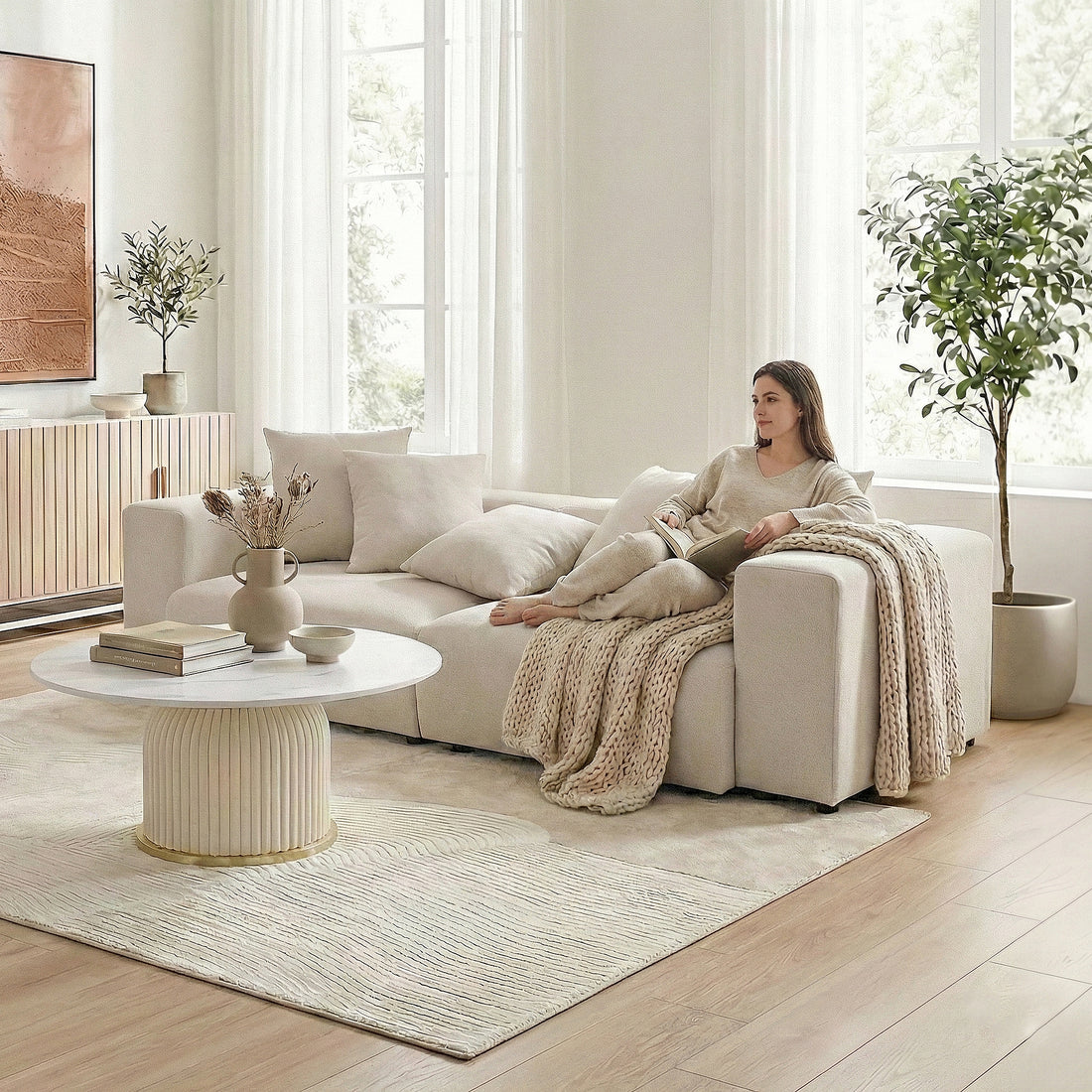 Beige L-shaped sectional sofa in a bright living room with a woman lounging