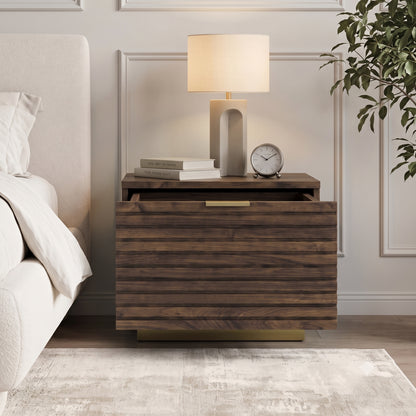 Nightstand styled in a bedroom next to a bed with lamp and books