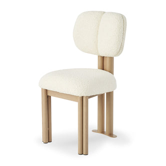 Norii Boucle Fabric Dining Chair features a cream white, padded bouclé seat and split backrest on a light wood cylindrical frame, enhancing modern dining with comfort and style.
