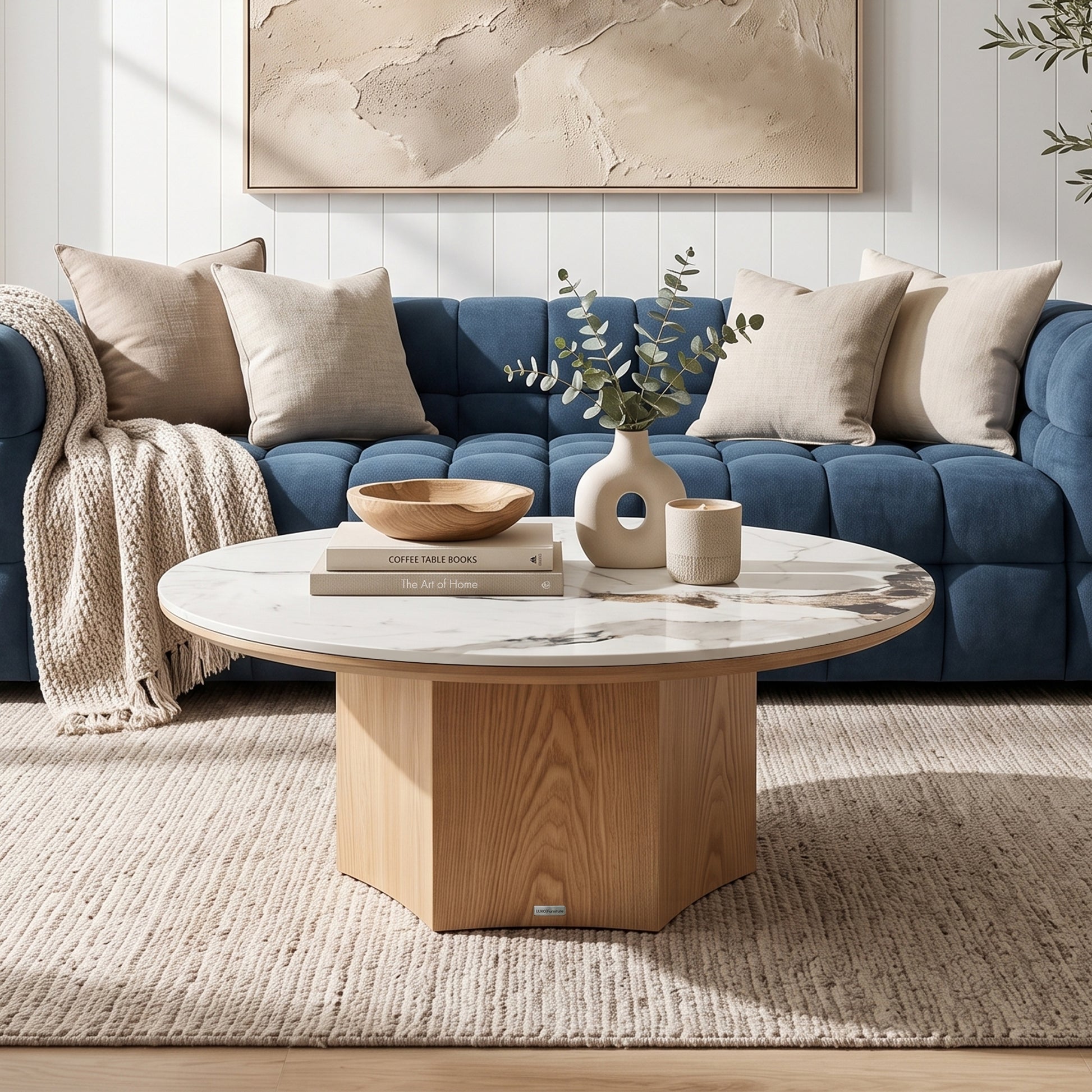 Round marble-top coffee table styled in a modern living room