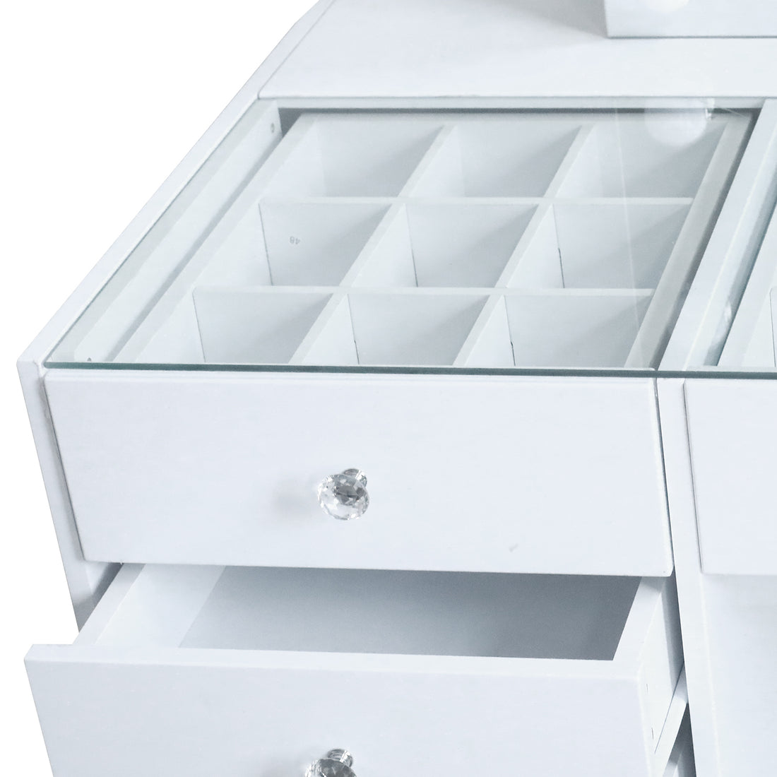 Close-up view of vanity drawer knobs and compartments on white background