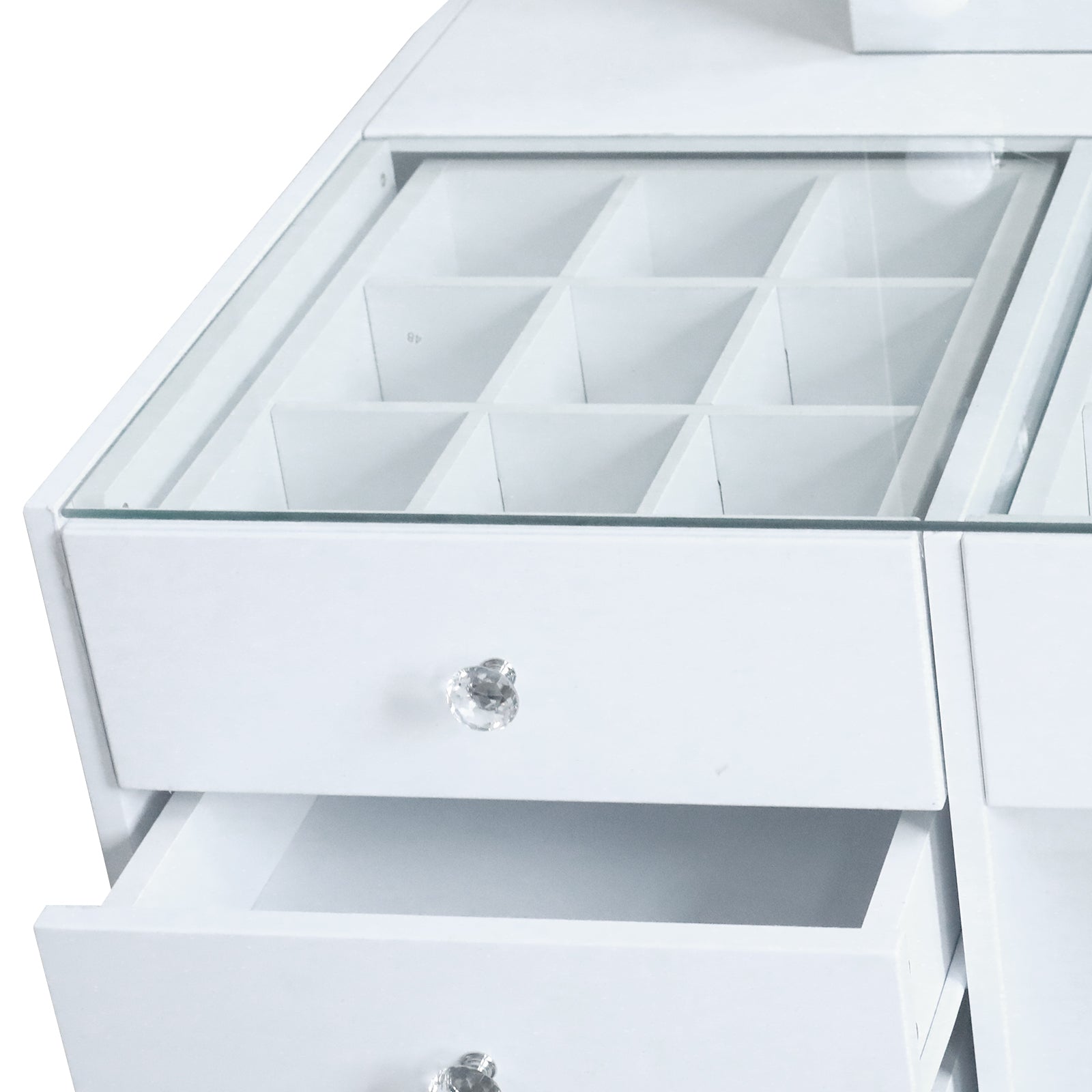 Close-up view of vanity drawer knobs and compartments on white background