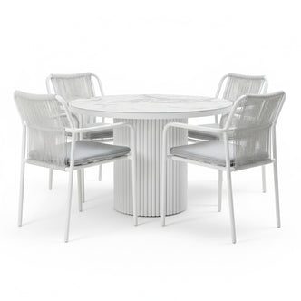Evone 4 Seater Stone Outdoor Dining Table Set in Light Grey; round table with marble-patterned top, fluted pedestal base, surrounded by four chairs featuring woven backs and gray cushions.