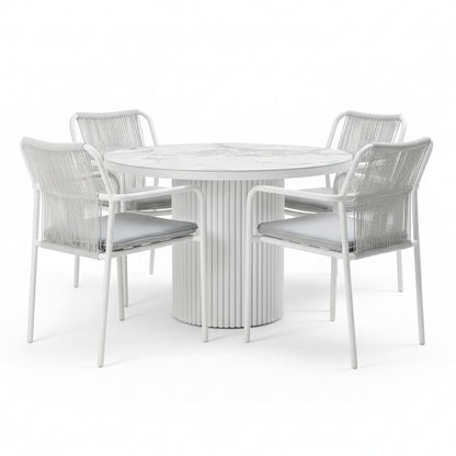 Evone 4 Seater Stone Outdoor Dining Table Set in Light Grey; round table with marble-patterned top, fluted pedestal base, surrounded by four chairs featuring woven backs and gray cushions.