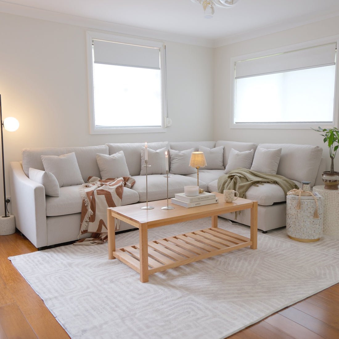 Light-colored sectional sofa in a bright, modern living room.