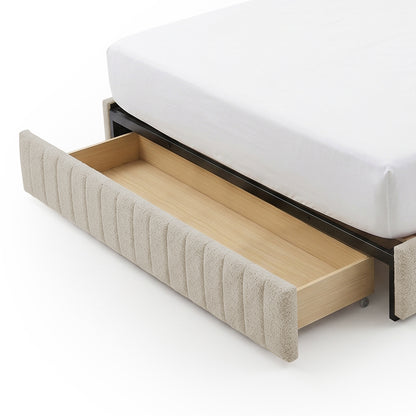 Under-bed storage drawer pulled out from upholstered bed frame on white background