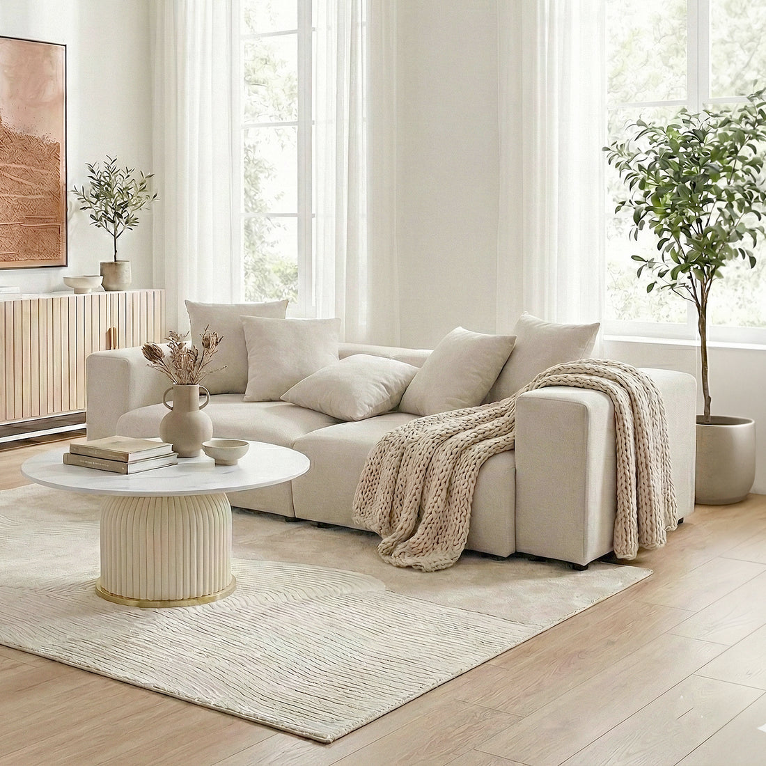 Beige sectional sofa in a minimalist lifestyle setting with coffee table and décor