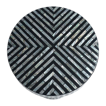 Round decorative inlay top with black and iridescent geometric pattern on white background