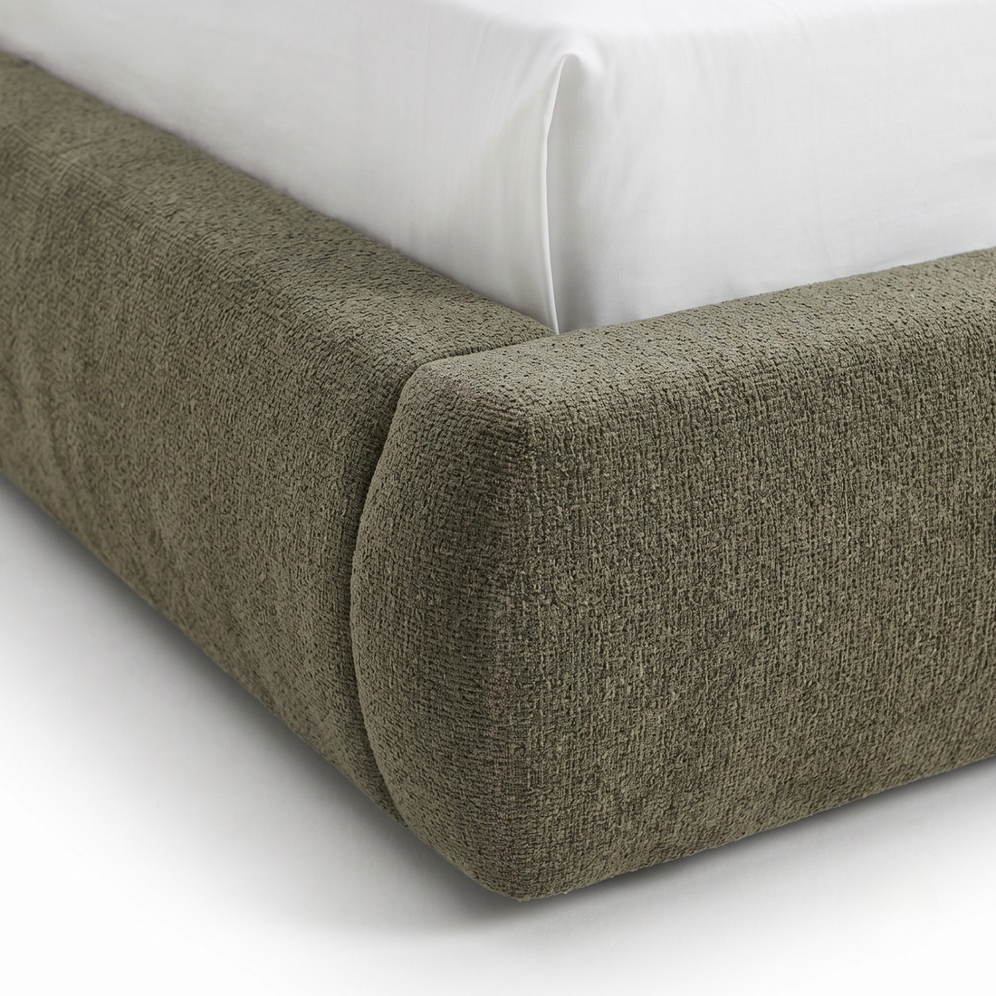 Close-up of upholstered bed frame corner with textured fabric