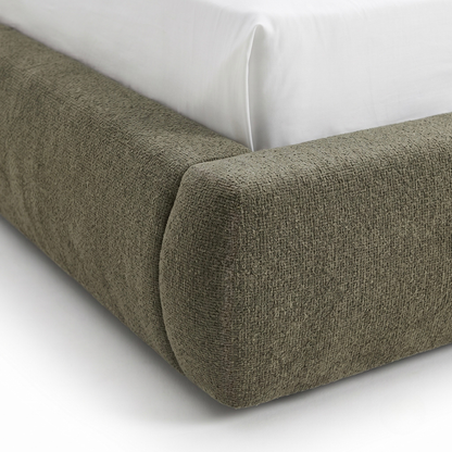 Close-up of upholstered bed frame corner with textured fabric