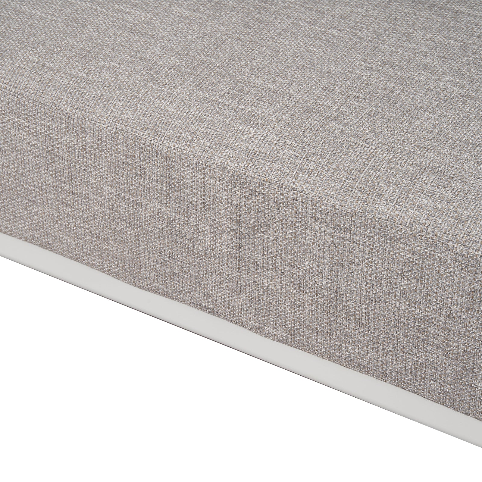 Close-up of the corner and fabric texture of a mattress or cushion on a white background.