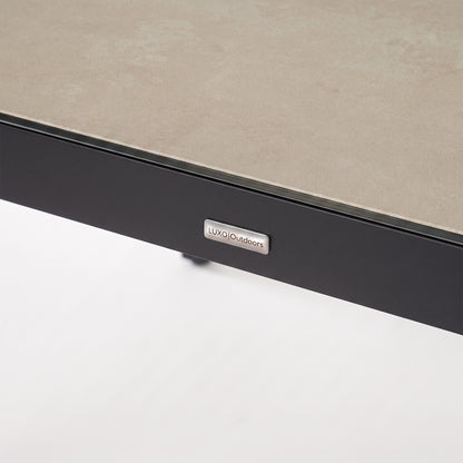 Close-up of a furniture corner with textured surface and brand logo on white background.