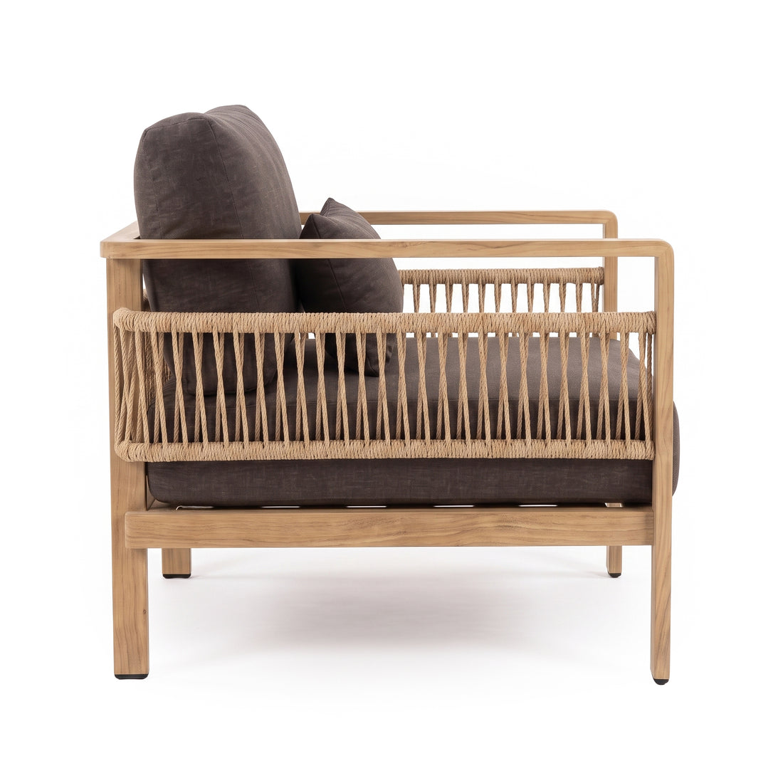 Side view of a modern armchair with wood frame and dark cushions on white background