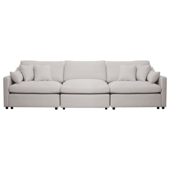 Light beige three-seat sofa with throw pillows on a white background