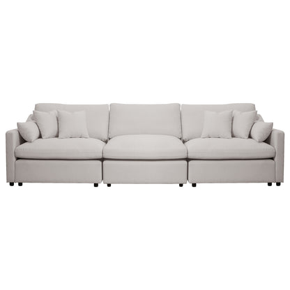 Light beige three-seat sofa with throw pillows on a white background