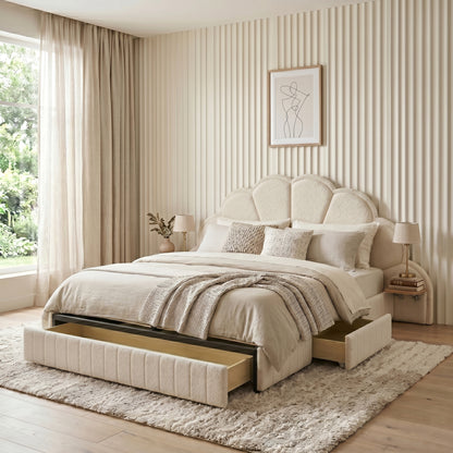 King bed with scalloped headboard and open underbed drawer in a bright styled bedroom