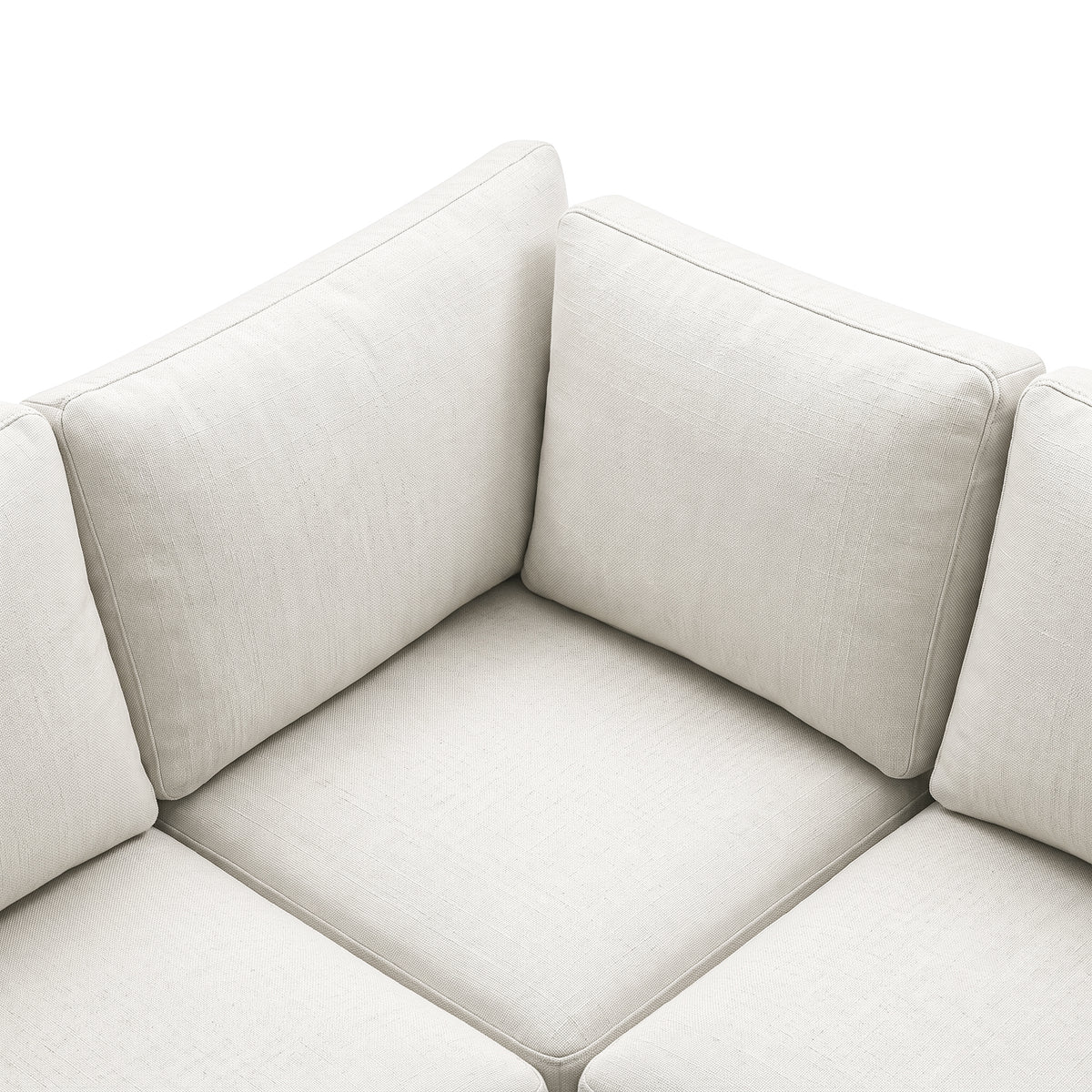 Close-up of the textured cream sectional sofa corner and cushions