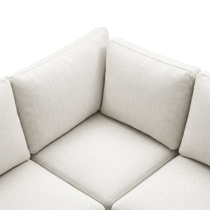 Close-up of the textured cream sectional sofa corner and cushions