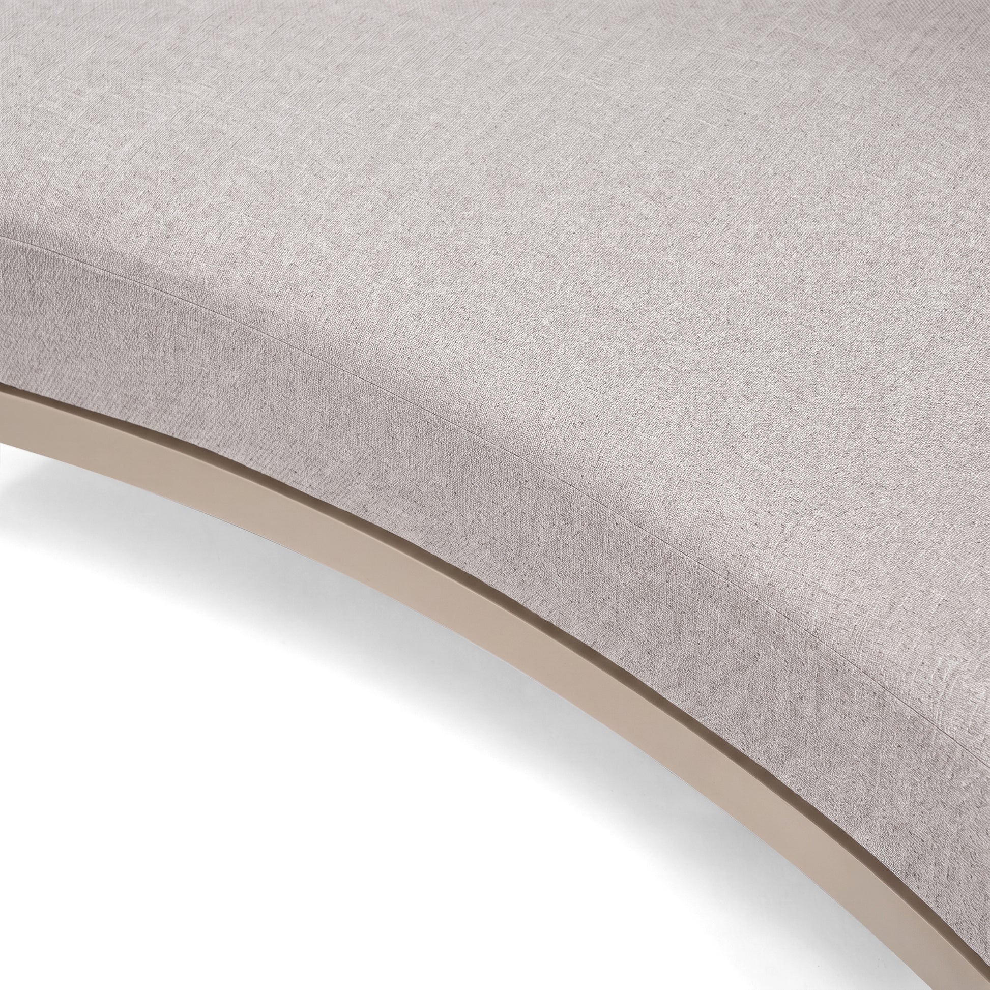 Close-up of a curved upholstered furniture surface on a white background.