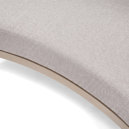 Close-up of a curved upholstered furniture surface on a white background.