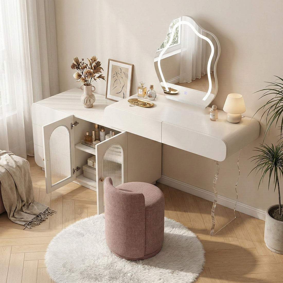 White vanity set in a styled room with pink round stool and decorative accessories