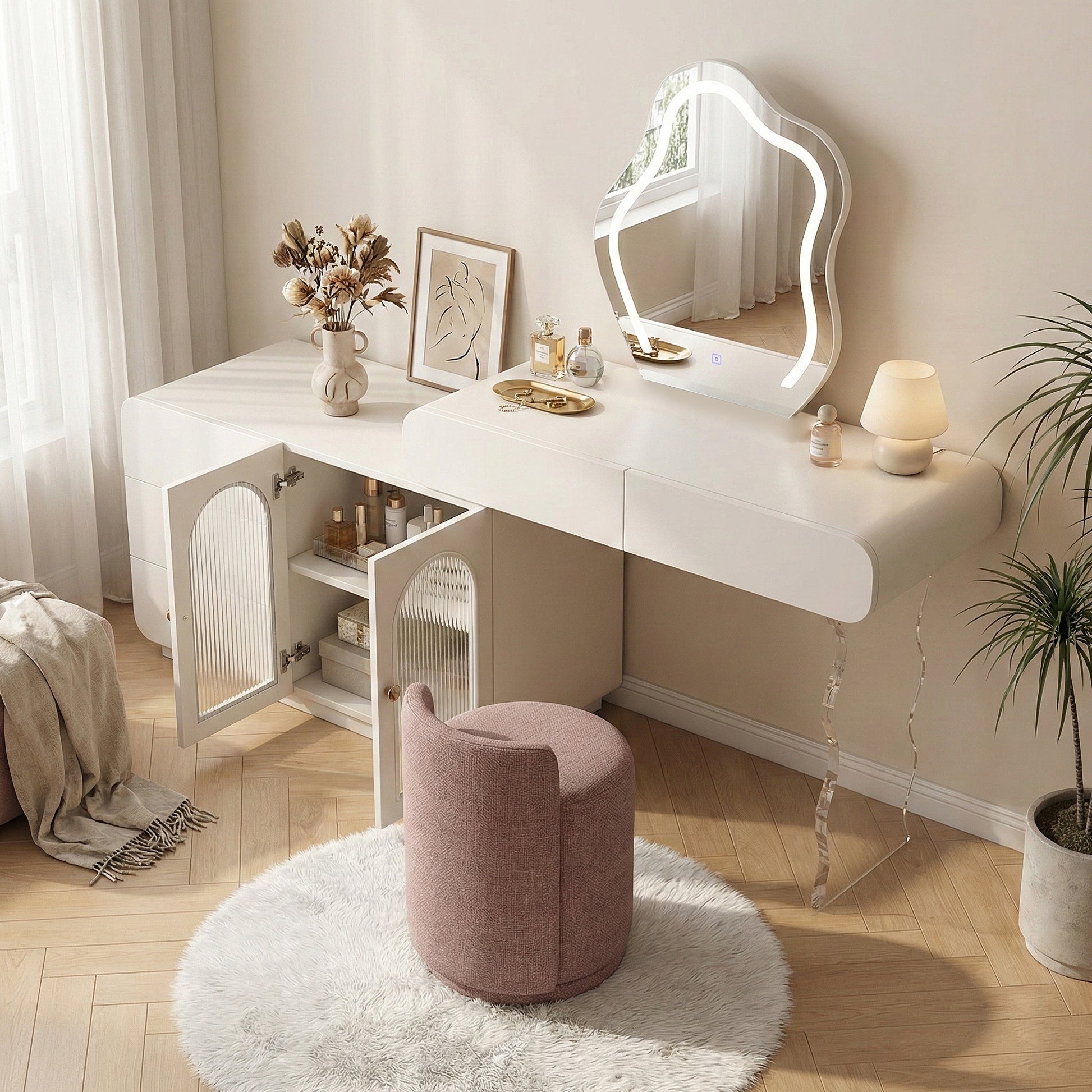 White vanity set in a styled room with pink round stool and decorative accessories